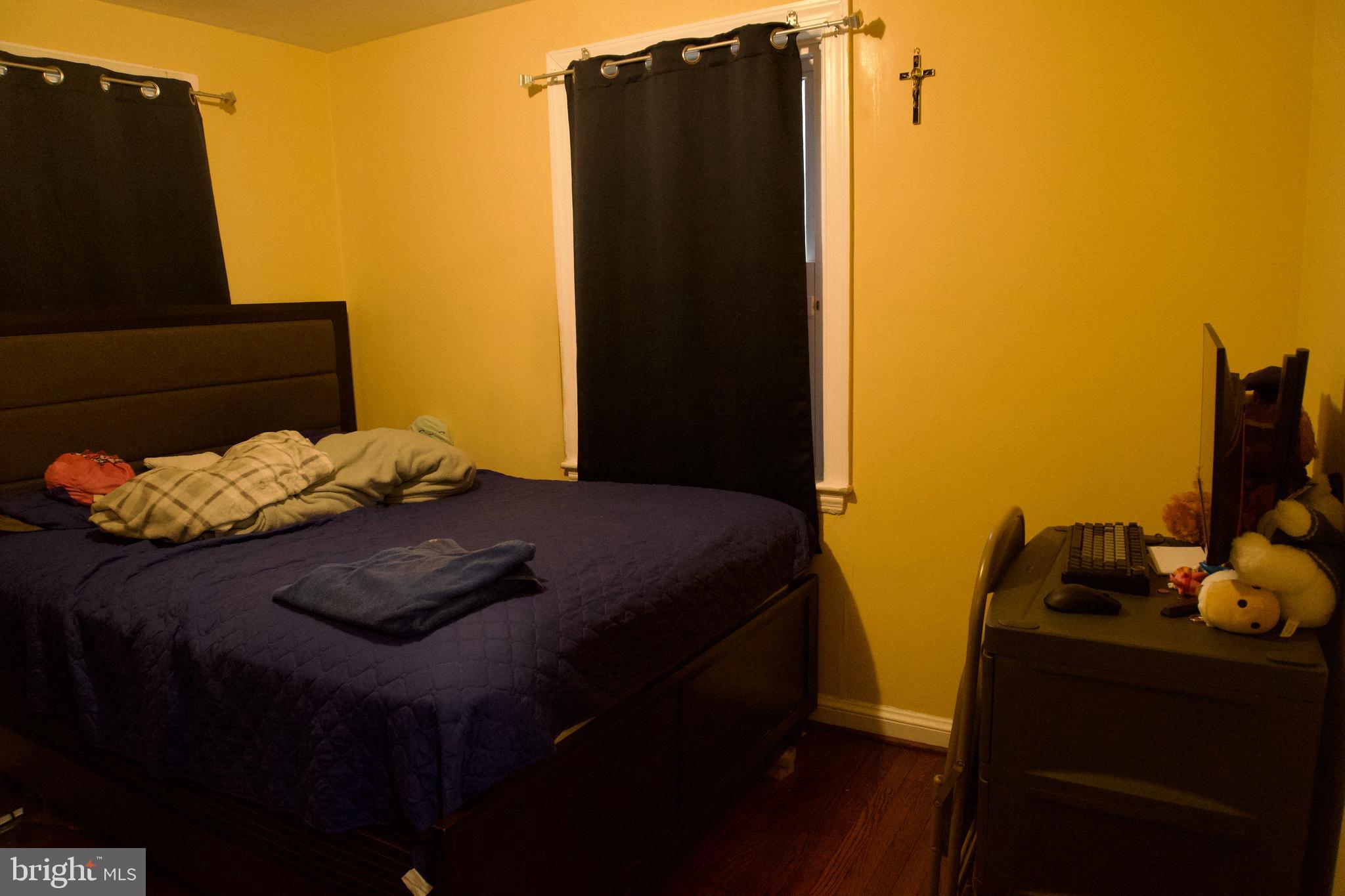 5702 Landover Road Hyattsville, MD 20784 - Photo 10 of 18 a bedroom with a bed and teddy bear on bed