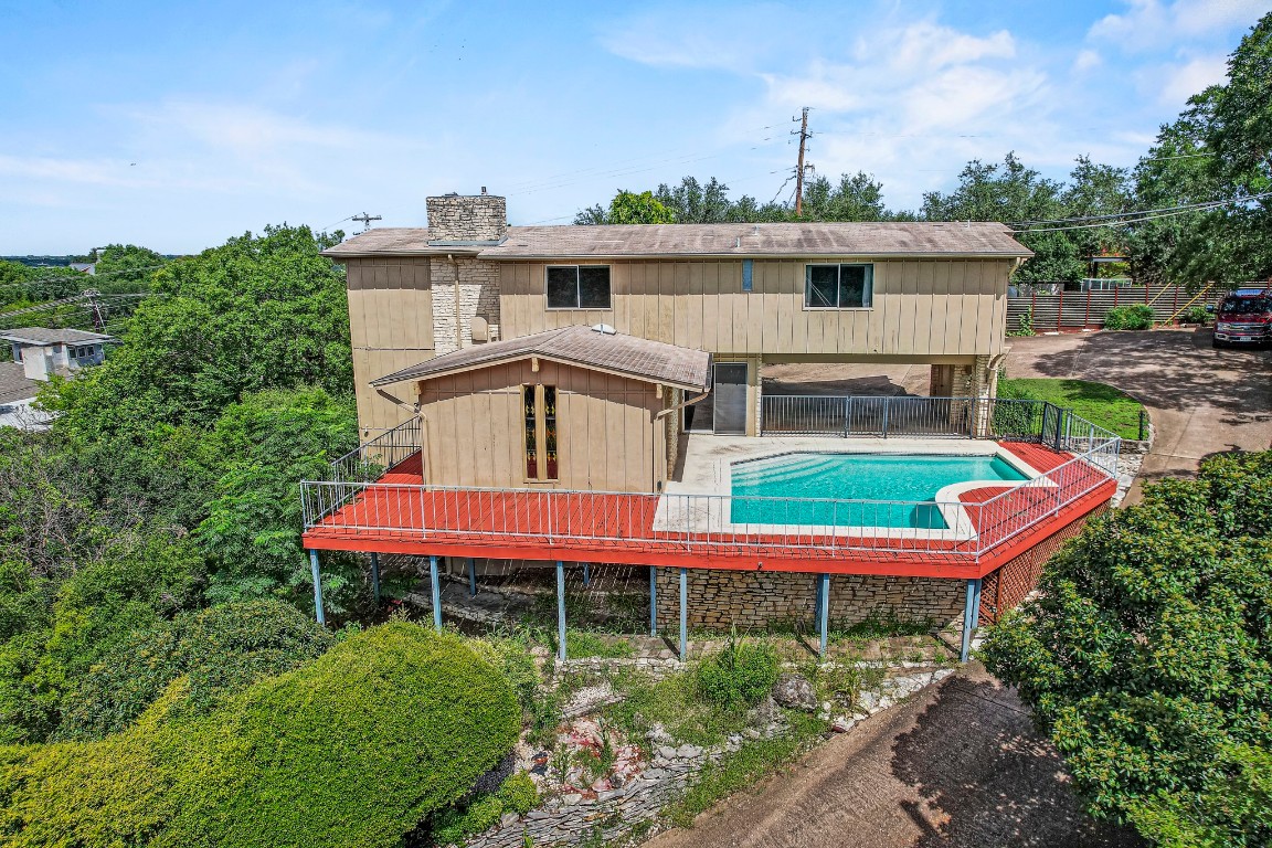 Rear view of house featuring a chimney