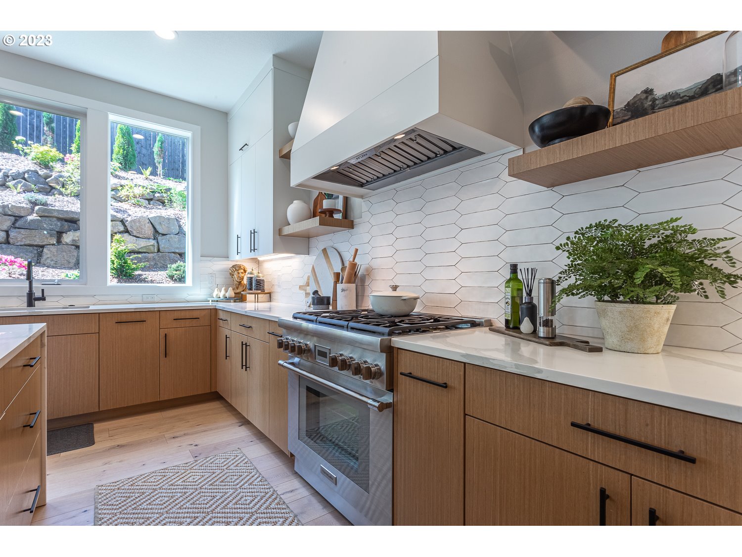 2000 Northwest 33rd Way Camas, WA 98607 - Photo 18 of 48 a kitchen with a sink a stove cabinets and a potted plant