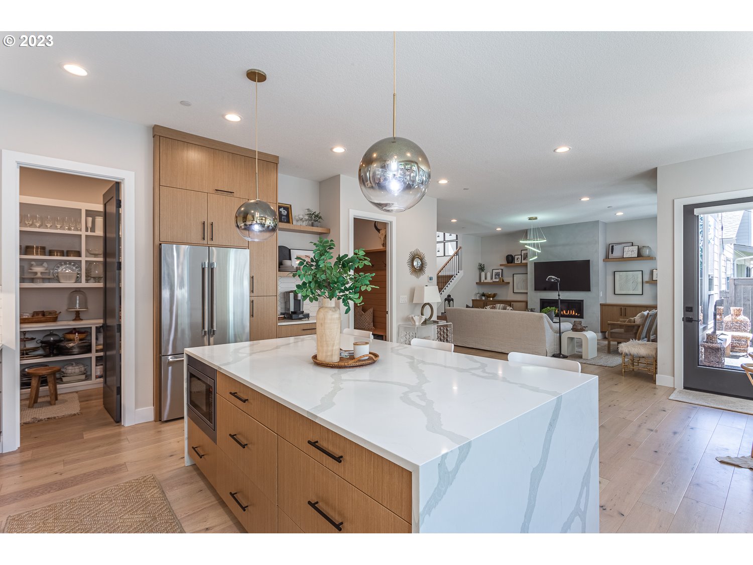 2000 Northwest 33rd Way Camas, WA 98607 - Photo 21 of 48 a kitchen with stainless steel appliances granite countertop a refrigerator a sink dishwasher and a dining table with wooden floor