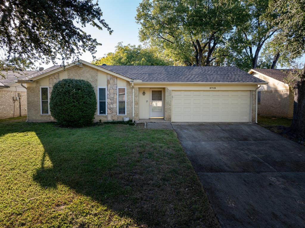 a view of a house with yard and a garden