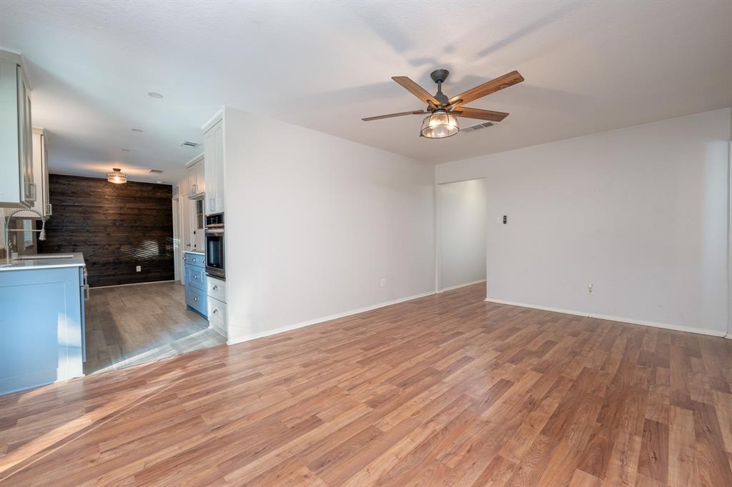 2713 Springlake Court Irving, TX 75060 - Photo 3 of 14 a view of a livingroom with a hardwood floor and a ceiling fan