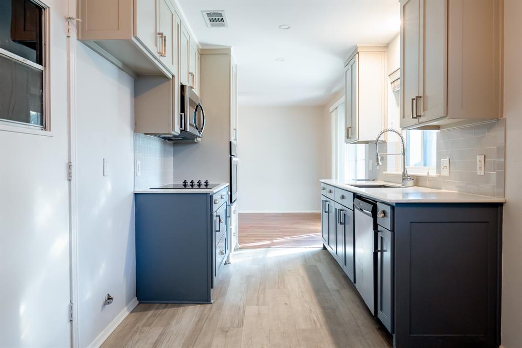 2713 Springlake Court Irving, TX 75060 - Photo 5 of 14 a kitchen with stainless steel appliances granite countertop a refrigerator and a sink