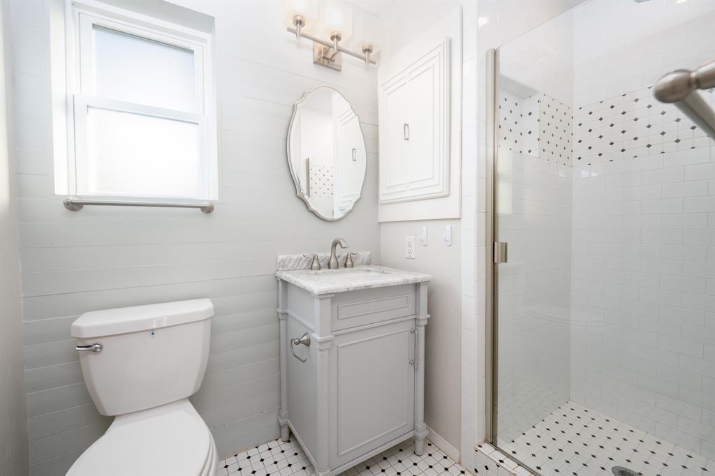 2713 Springlake Court Irving, TX 75060 - Photo 9 of 14 a bathroom with a toilet a sink and a mirror