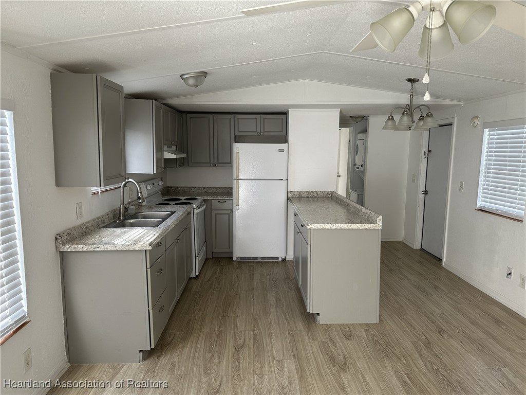2273 Kansas Street Sebring, FL 33870 - Photo 3 of 10 a kitchen with a stove a refrigerator and a sink