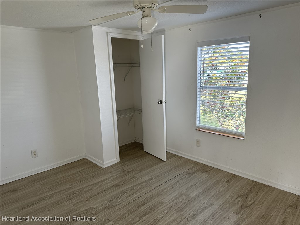 2273 Kansas Street Sebring, FL 33870 - Photo 9 of 10 a view of an empty room with wooden floor and a window