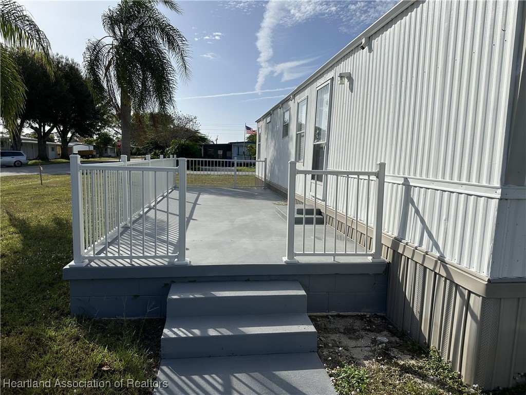 2273 Kansas Street Sebring, FL 33870 - Photo 10 of 10 a view of balcony with wooden floor and outdoor seating