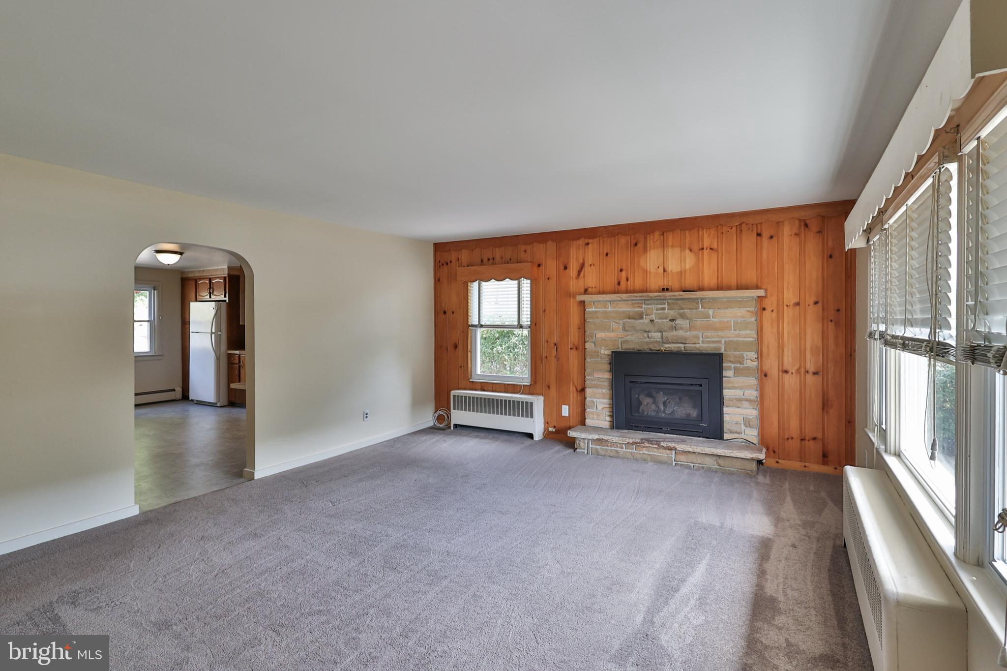 769 Lafayette Avenue Palmerton, PA 18071 - Photo 5 of 46 an empty room with large windows and fireplace