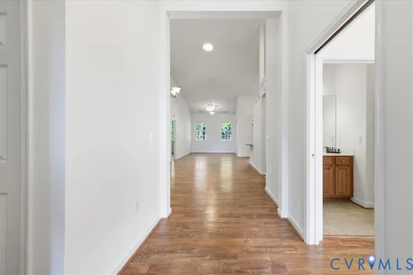 a view of a hallway with wooden floor
