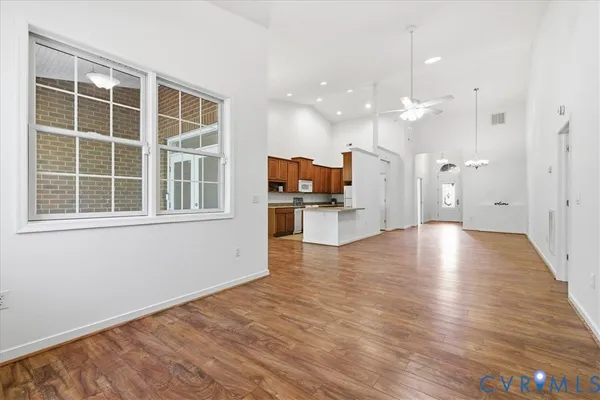 a view of a living room with hardwood floor and a large window
