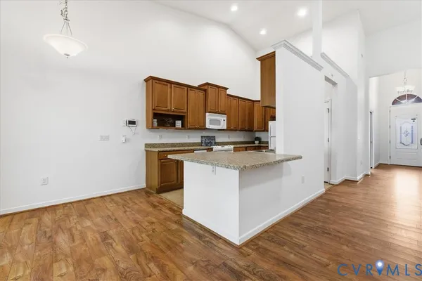 a kitchen with stainless steel appliances a stove top oven a sink and a refrigerator