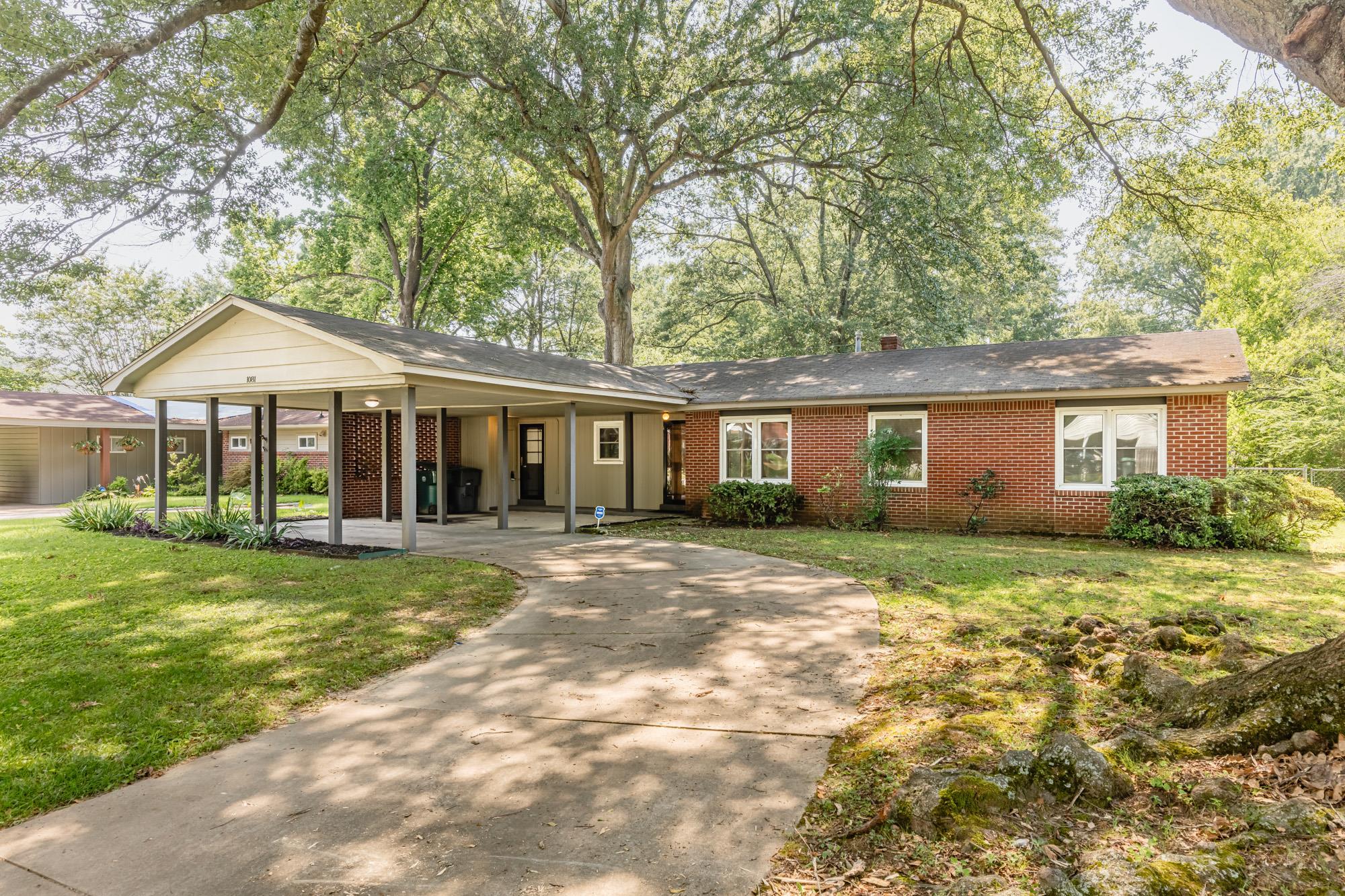 1081 Ivy Road Memphis, TN 38117 - Photo 1 of 25 a front view of a house with a garden