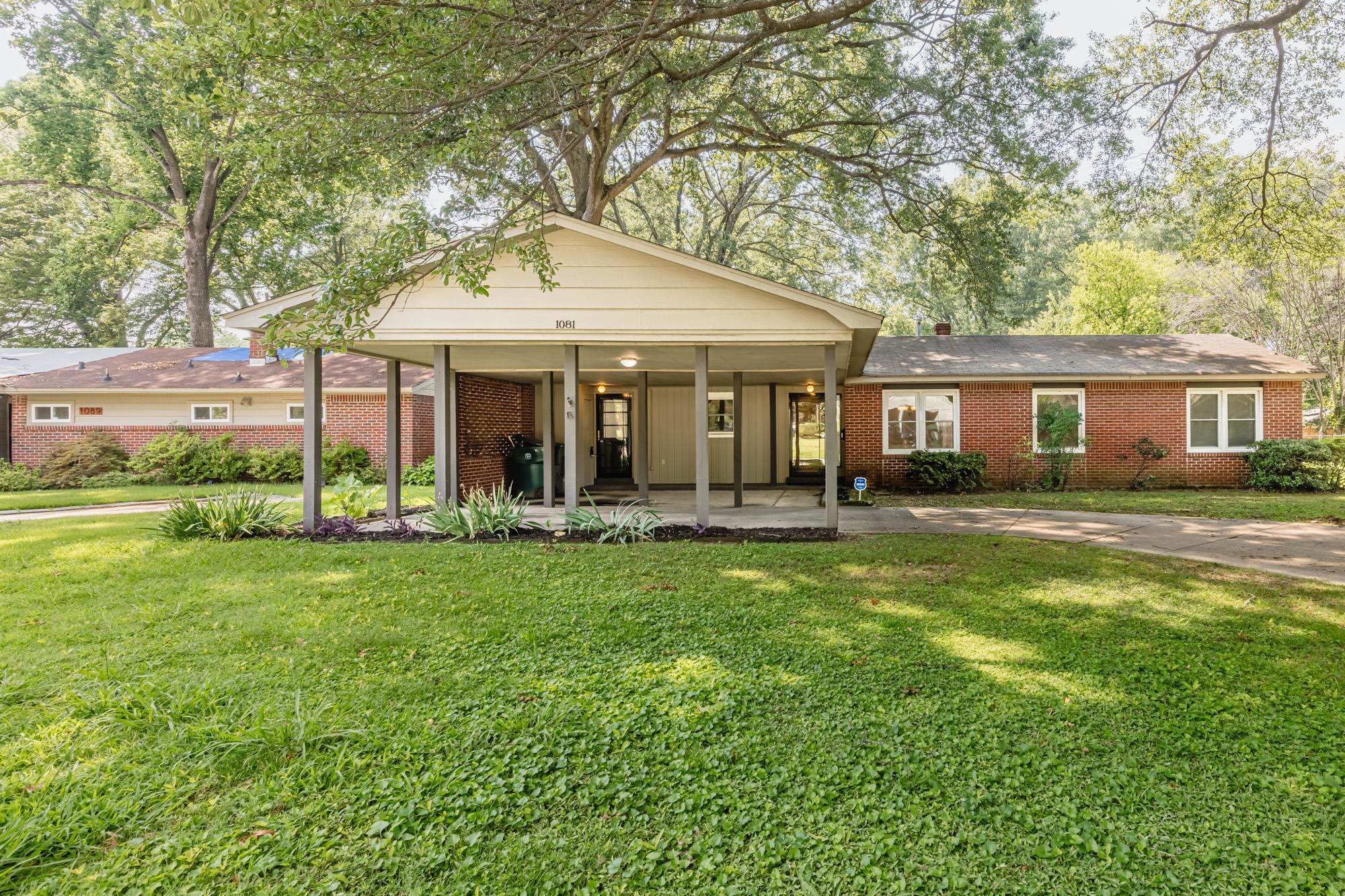1081 Ivy Road Memphis, TN 38117 - Photo 13 of 25 a front view of a house with a garden and porch