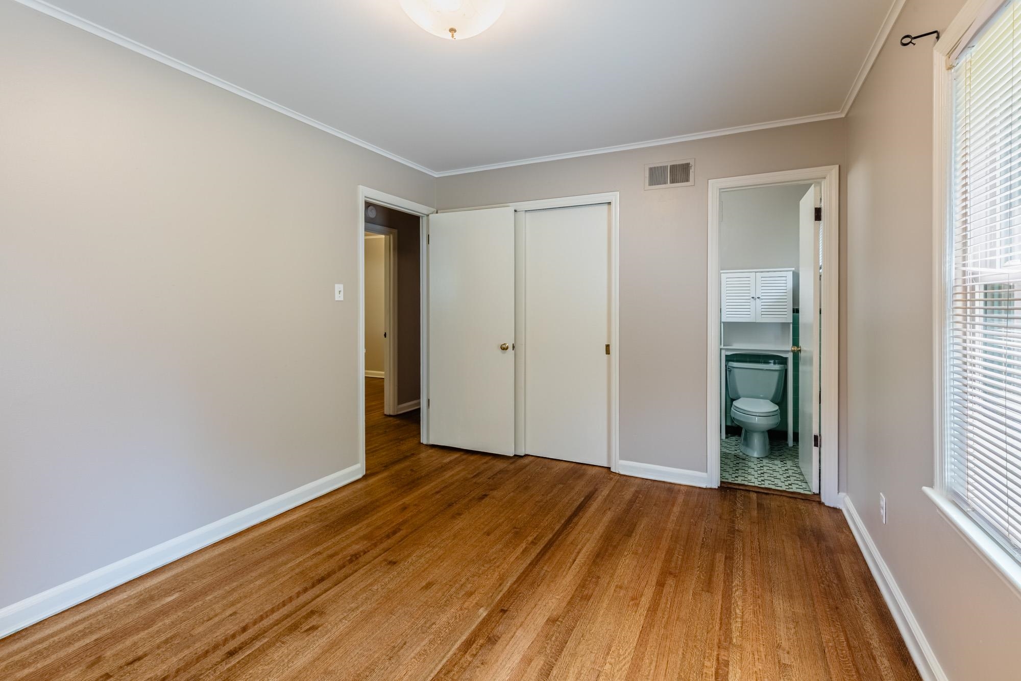 1081 Ivy Road Memphis, TN 38117 - Photo 23 of 25 a view of a room with wooden floor and brick walls