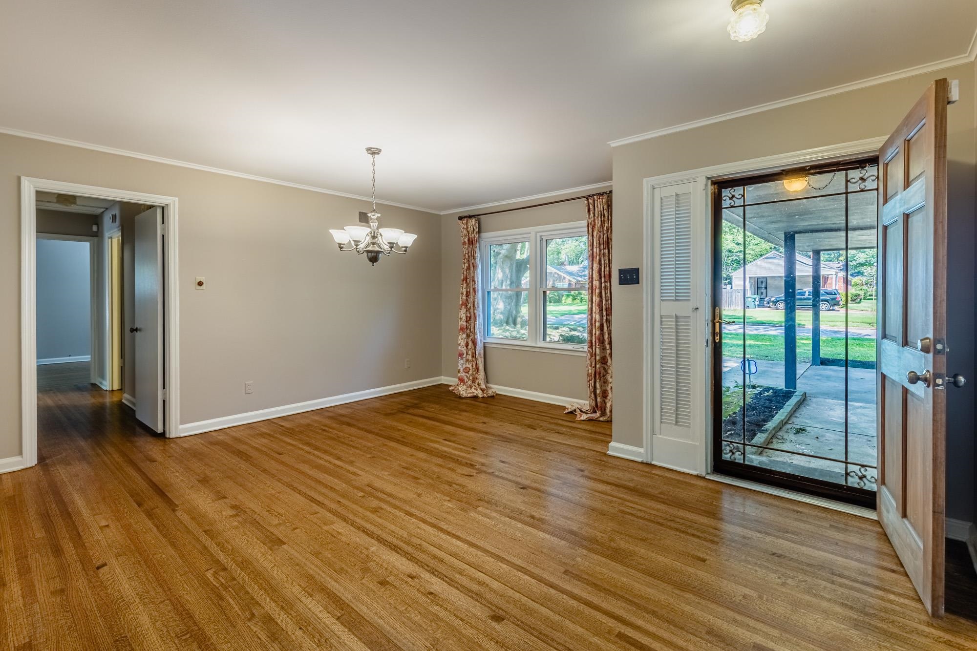 1081 Ivy Road Memphis, TN 38117 - Photo 3 of 25 wooden floor in an empty room with a window
