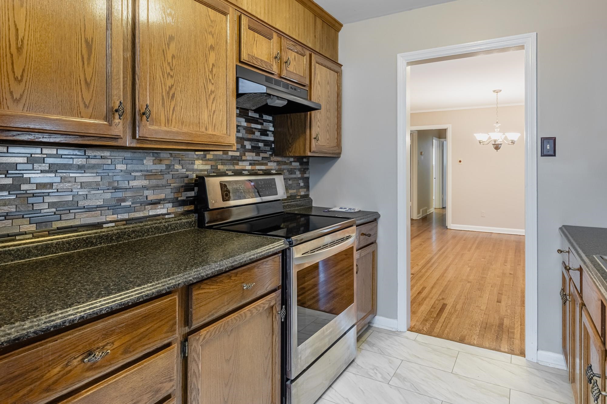 1081 Ivy Road Memphis, TN 38117 - Photo 6 of 25 a kitchen with stainless steel appliances granite countertop a sink stove and cabinets
