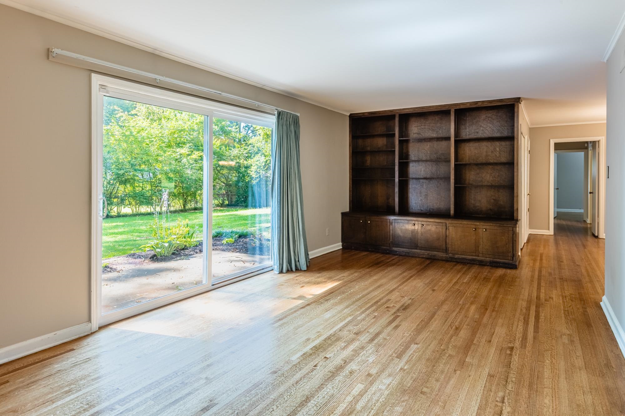 1081 Ivy Road Memphis, TN 38117 - Photo 7 of 25 a view of empty room with wooden floor and fan