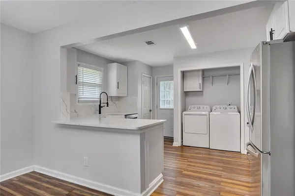 a view of a kitchen sink cabinets and wooden floor