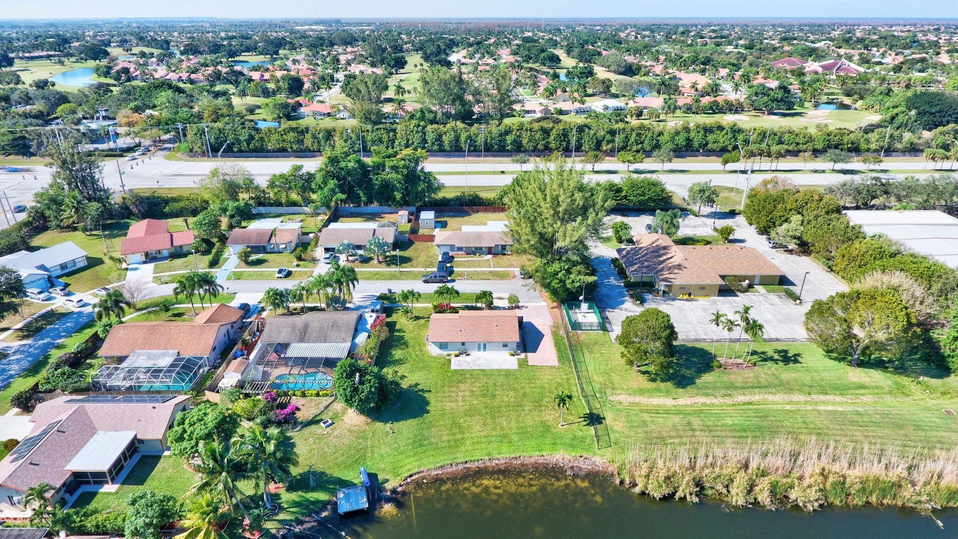 9989 Liberty Road Boca Raton, FL 33434 - Photo 35 of 44 an aerial view of lake residential houses with outdoor space and lake view
