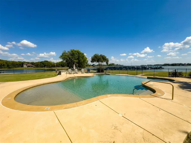 a view of a swimming pool and lake from nearby houses