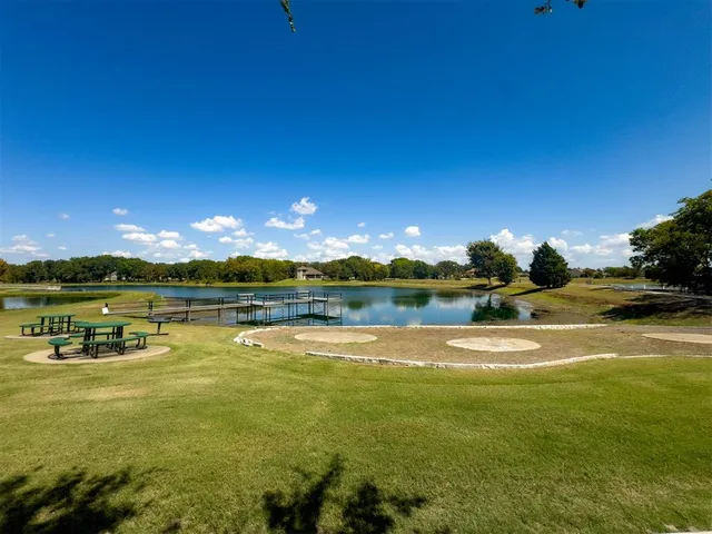 a view of a lake with houses in the back