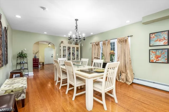 a view of a dining room with furniture wooden floor and chandelier