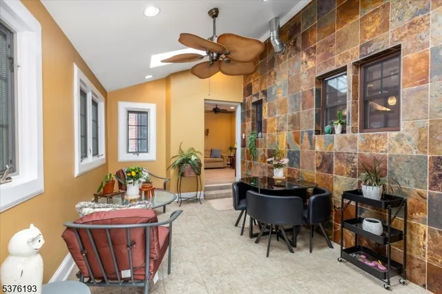 a living room with furniture a chandelier and a large window