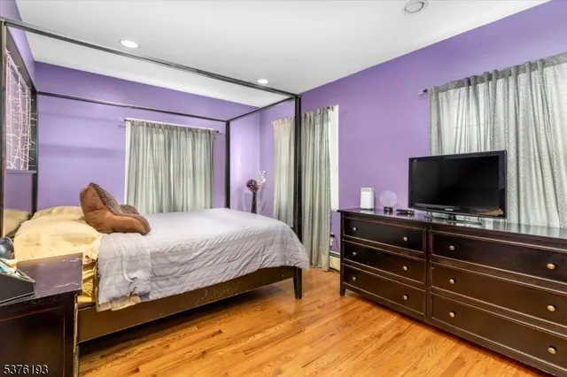 a bedroom with a bed and flat screen tv