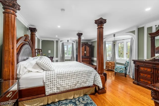 a bedroom with a large bed and a large window