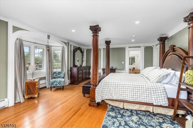 a bedroom with a large bed and a chandelier