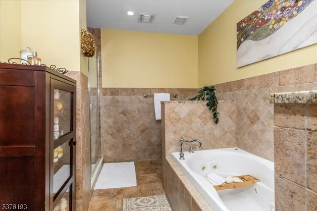 a bathroom with a tub and shower