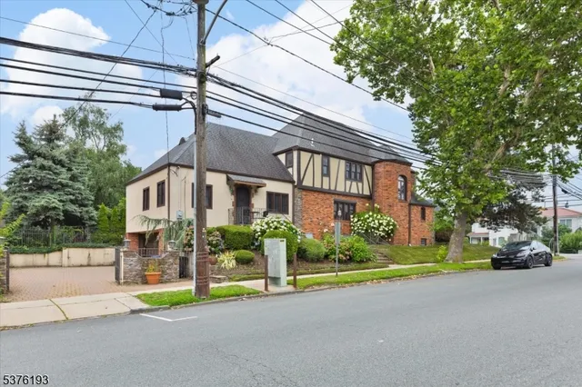 a view of a house with a garden and pathway