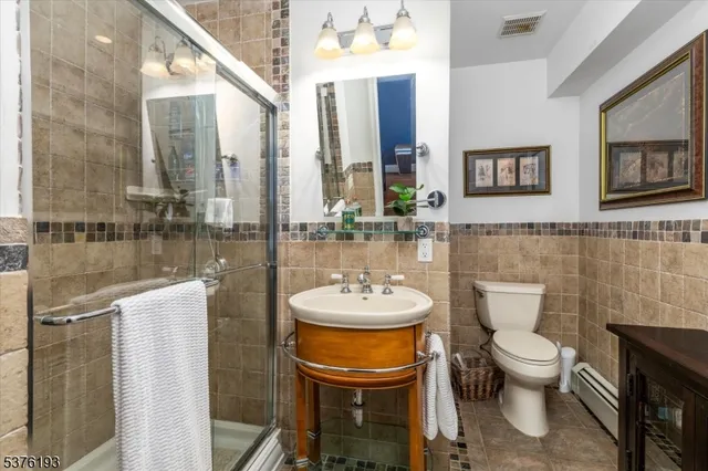 a bathroom with a toilet a sink and mirror