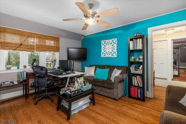 a living room with furniture a rug and a large window