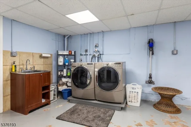 a utility room with sink washer and dryer