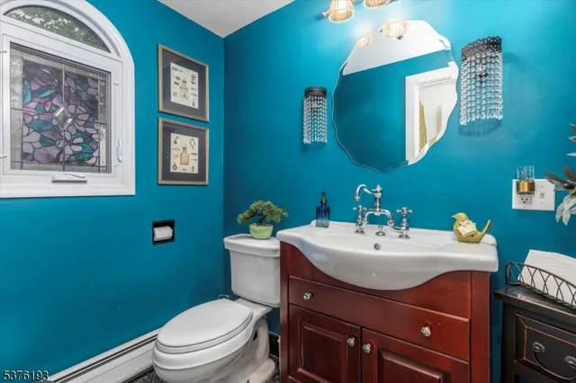 a bathroom with a toilet a sink and mirror