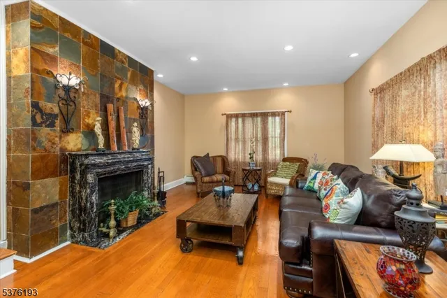 a living room with furniture a fireplace and a large window