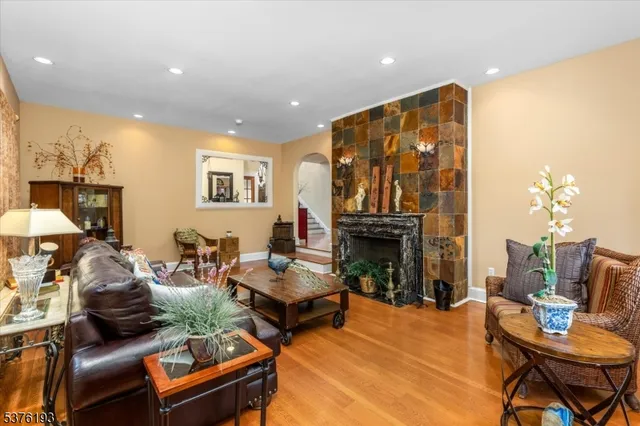 a living room with fireplace furniture and a chandelier