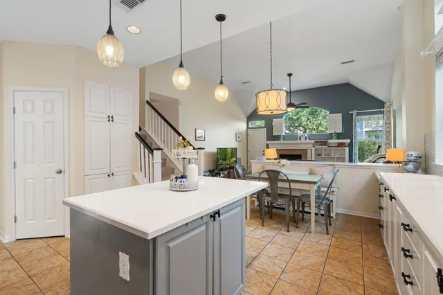 a kitchen with a table chairs and white walls