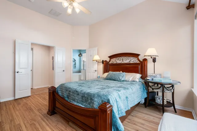 a bedroom with a bed and a chandelier