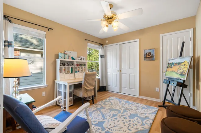 a view of a livingroom with workspace and a window