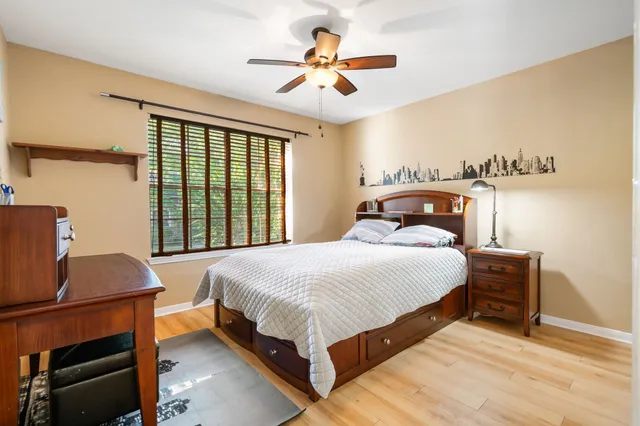 a bedroom with a bed and a chandelier