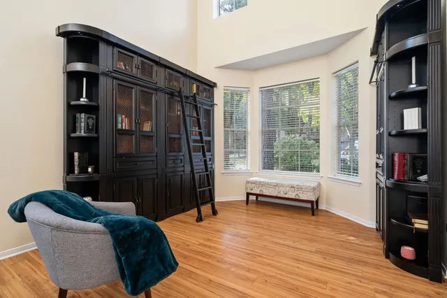 a living room with furniture and a book shelf