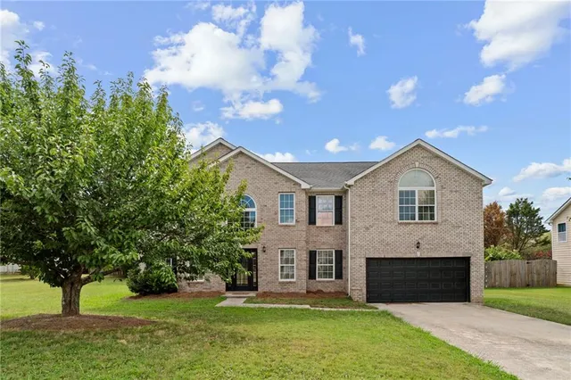 a front view of house with yard and green space