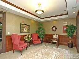 3701 Baron Cooper Pass, Unit 203 Raleigh, NC 27612 - Photo 2 of 10 Lobby entrance to elevator and houses the individual mailboxes for each unit. Can only gain access to elevator with personal key. Olde Raleigh condos also include covered garage parking on basement level.