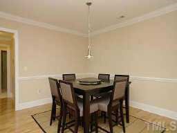 3701 Baron Cooper Pass, Unit 203 Raleigh, NC 27612 - Photo 4 of 10 Dining room is accentuated with chair-high crown molding. Opens up to living room and foyer...very spacious!
