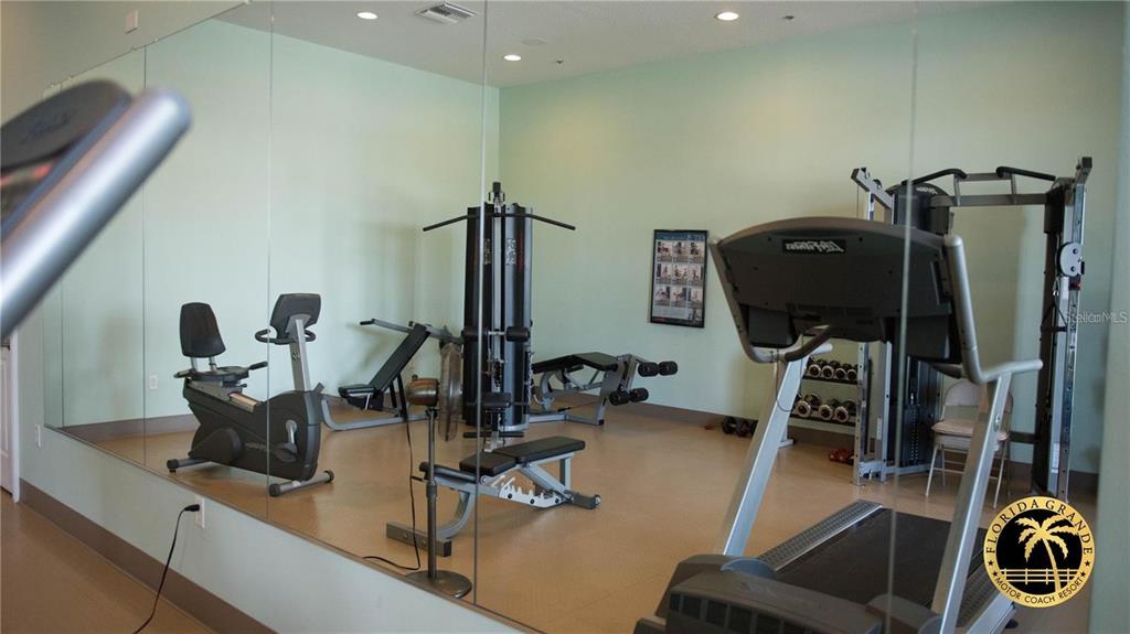 9477 Southeast 49th Terrace Webster, FL 33597 - Photo 18 of 31 a view of a workspace with furniture and gym equipment