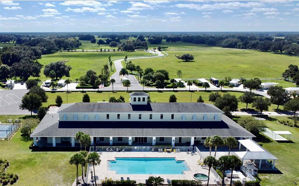 9477 Southeast 49th Terrace Webster, FL 33597 - Photo 24 of 31 an aerial view of a house with a garden and lake view