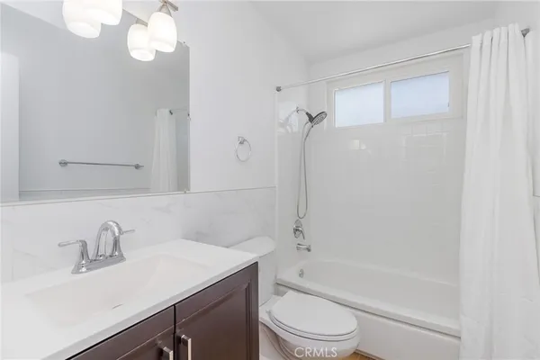 a bathroom with a sink a toilet and a bathtub