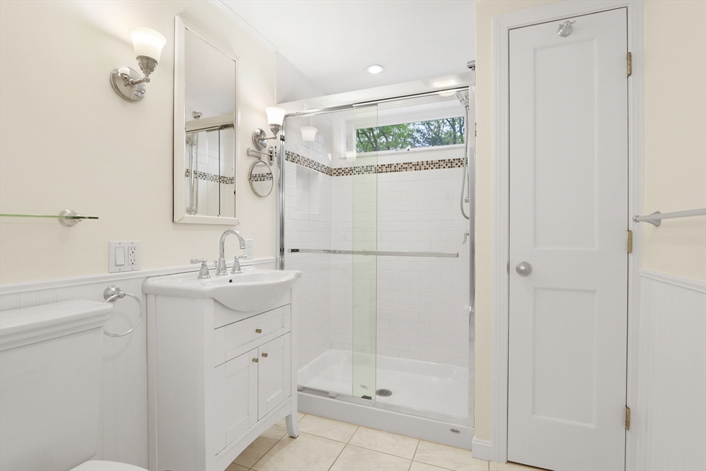 28 Longfellow Road Natick, MA 01760 - Photo 15 of 30 a bathroom with a shower a sink and mirror